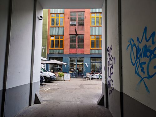 View of the outside of The Visit Coffee Roastery from the driveway into the courtyard at The Visit Coffee Roastery in Berlin