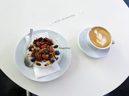 Vegan oatmeal and cappuccino with oatmilk at The Visit Coffee Roastery at The Visit Coffee Roastery in Berlin