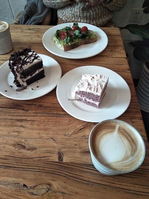 Avocado on toast (without feta), coffee with cashew milk, two cakes. at Egg in Shanghai