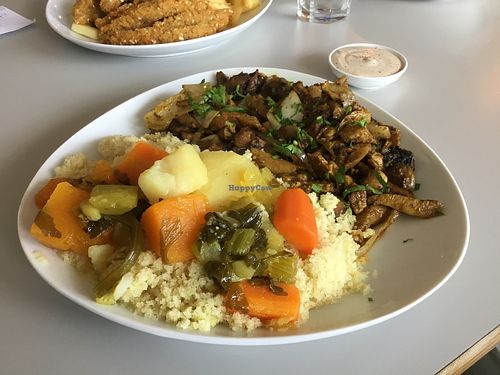 Shawarma on a plate with hot couscous  at Hummus Bar in Haifa