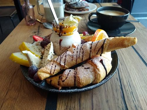 Sweet breakfast with croissants, fruits, margarine, nuts, various spreads and soy yoghurt. at Veg room in Berlin