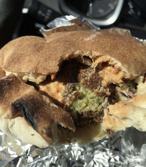 Falafel pita w hummus, baba ganoush, harissa, tahini, purple cabbage and onions   at Naf Naf Grill in Eagan