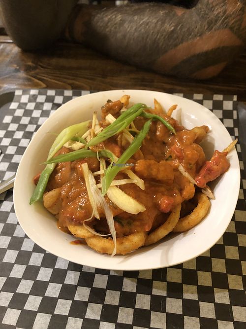 Butter chicken poutine on curly fries! at The Pizza Castle and Indian Curry in Vancouver