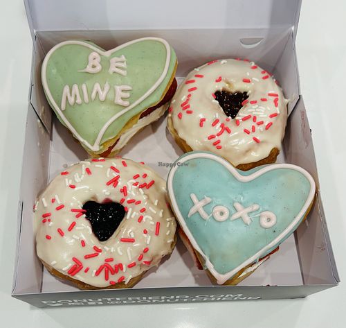 Valentine’s Day box of doughnuts. Two are strawberries with cream, one blueberry and one raspberry .  at Donut Friend - DTLA in Los Angeles