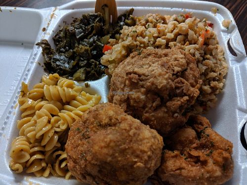Platter of Mac & cheese, collard greens, dirty rice & very well seasoned, delicious cauliflower balls at Soul Food Vegan in Houston