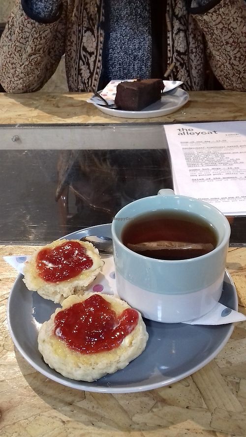 Tea and cakes. The table has a glass top with plants underneath! at The Alleycat in Inverness