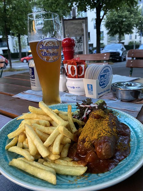 Vegan currywurst with fries and beer  at Das Bad in Munich