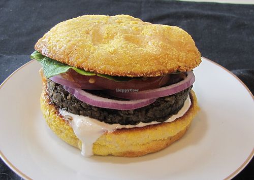 Black bean burger on a cornmeal roll with lettuce, tomato, red onions, and horseradish mayo. at A Full Taste in Decatur