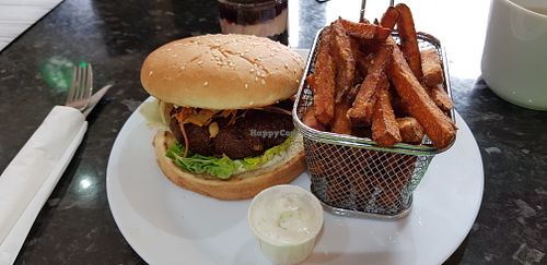 Jamaican Jerk veggie burger and sweet potato fries at Dynamite Raw Cafe in Bury
