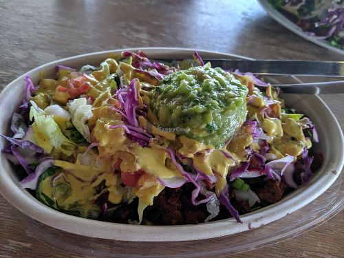 Delicious bowl - rice, black beans, pastor, red cabbage, cabbage, onions, peppers, salsa, cheese sauce, guacamole at Veegos in Houston