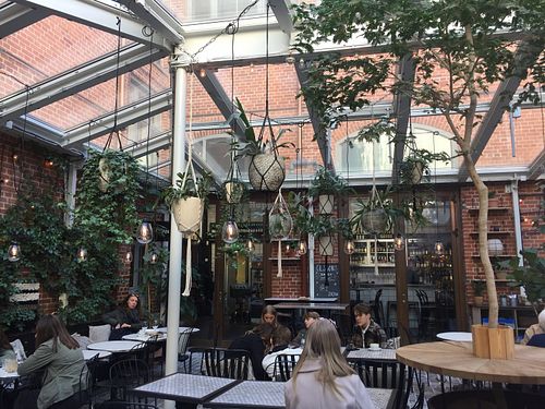 Cute and cozy green house patio at Kafé Magasinet in Gothenburg