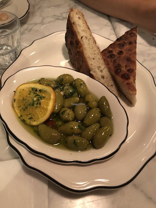 Olives in hot oil and focaccia  at Radis in Montreal