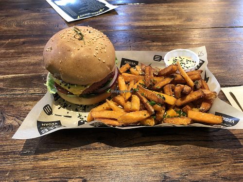 Signature MAD Burger with sweet potatoe fries! Best vegan burger I’ve tried so far in Europe!! at Mad Mad Vegan - Chueca in Madrid