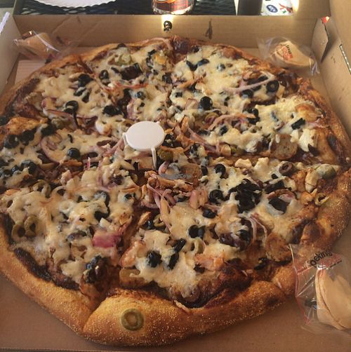 Vegan pizza topped with olives, vegan chicken and sausage  at Tomato Joe's Pizza Express in Valencia