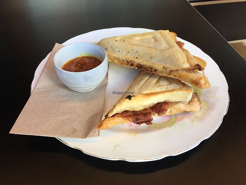 Sausage, sauerkraut and hashbrown jaffle with chutney at For Change Cafe - Melbourne Uni. in Parkville