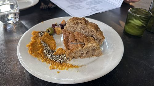 Amuse: housemade focaccia, carrot spread, za'atar oil, ras el hanout marinated olives, gigante bean, fennel & caper salad  at Millennium in Oakland