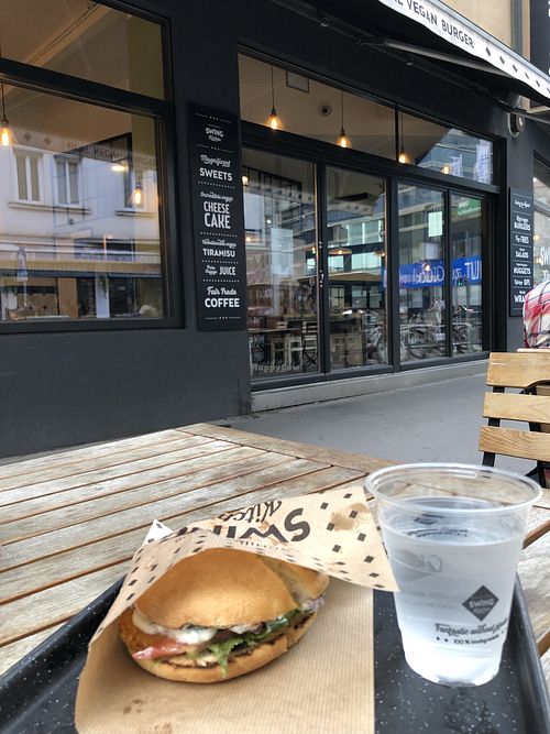 Vienna burger (Schnitzel), on outdoor table   at Swing Kitchen - Schwedenplatz in Vienna