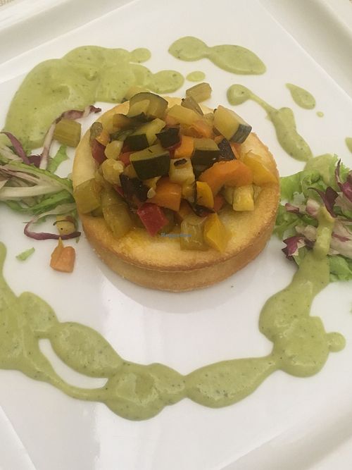 Diced vegetables on small crackers and courgette cream  at Osteria Del Melograno in Cremona