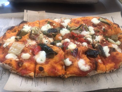 large vegan pizza with caponata at Tia's Pizza in Ljubljana