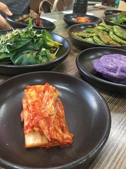 Side dishes from back to front: seasoned taro root, salad and vegan kimchi.  at Babiboyak in Jeju