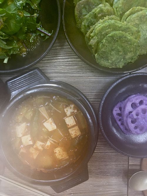  Clockwise: salad, chive pancakes, lotus root and doenjangjigae   at Babiboyak in Jeju