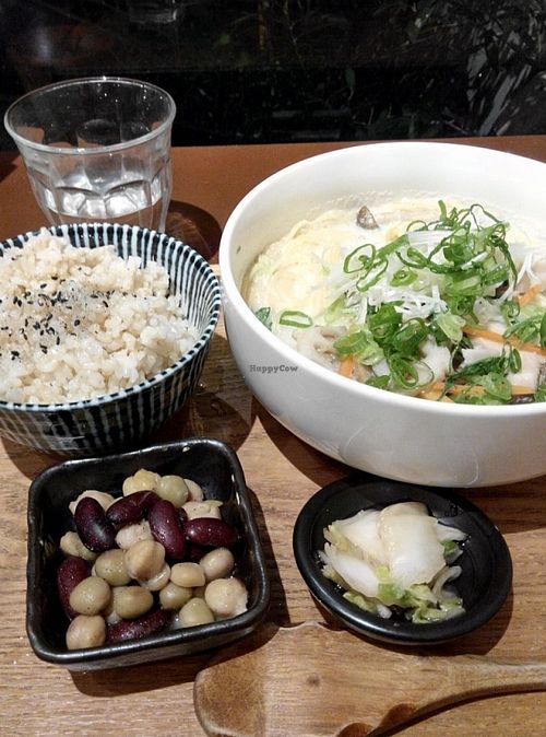 Ramen in pork bone-like soup made of soya-milk. 

You can have noodles on it own.

I order it as a set and it came with a bowl of rice and 2 side dishes.

The whole set was just 1000Y (plus another 80Y for tax). 
 at Mumokuteki Vegan Cafe in Kyoto
