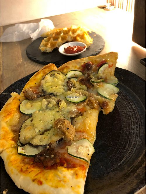 Vegan pizza and potato waffles at Queen's Healthy Diner in Nagoya