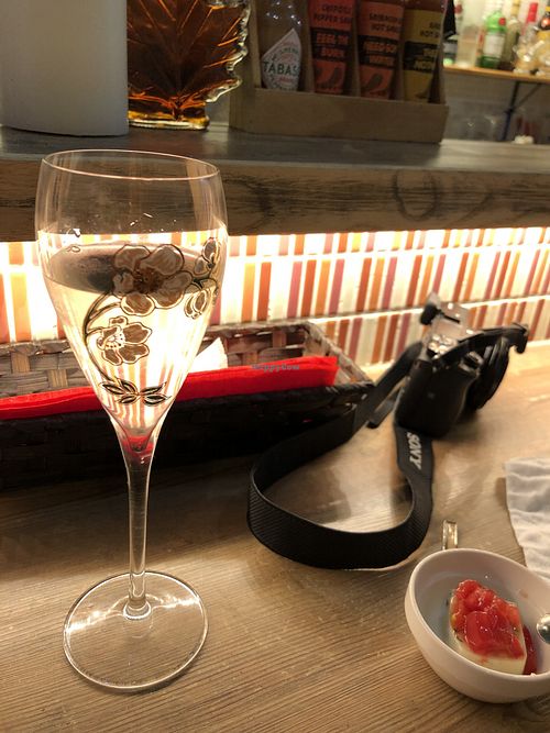 Sake and a tasty tofu appetizer at Queen's Healthy Diner in Nagoya