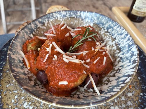 Vegan meatballs on homemade tomato sauce with bread  at Pele Surf Shack in Hook Of Holland