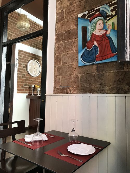The place is cozy and has some Paintings un Boteros’s style, perhaps to prevent people from eating too much  at 18 Grados in Gran Canaria