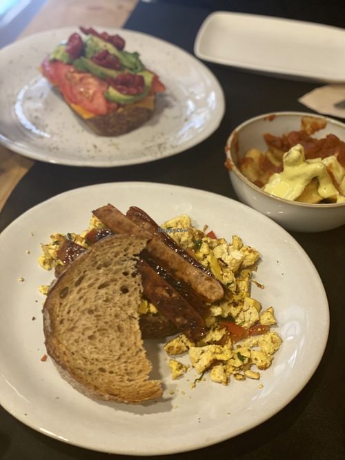 All day breakfast, sausage sandwich, patatas bravas and avocado tomato toast  at CactusCat Bar in Barcelona
