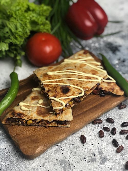 “Vegan quesadilla with beans, corn, vegetables, chili pepper and vegan sauce” at Monstera in Krasnodar