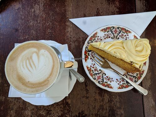 Oat milk latte & mango vanilla cake that is part of the afternoon tea at Pettigrew Tea Rooms in Cardiff