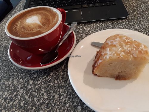 Large latte with soy milk and vegan lemon coconut bundt cake at Bacan Cafe in Vientiane