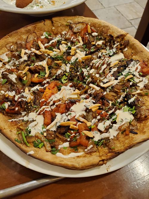 Requested this Zaatar flatbread VEGAN the day before, and it came with eggplant and more on it.   at Ein ElWadi in Haifa