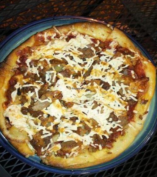 Vegan Surprise Pizza with seitan pepperoni, tempeh bacon, seasoned tofu, pineapple, onion, green pepper with chipotle mayo drizzled on top. at Brick Road Pizza Co in Grand Rapids