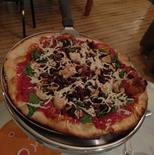 vegan pizza with spinach, garlic, kalamata olives at Brick Road Pizza Co in Grand Rapids