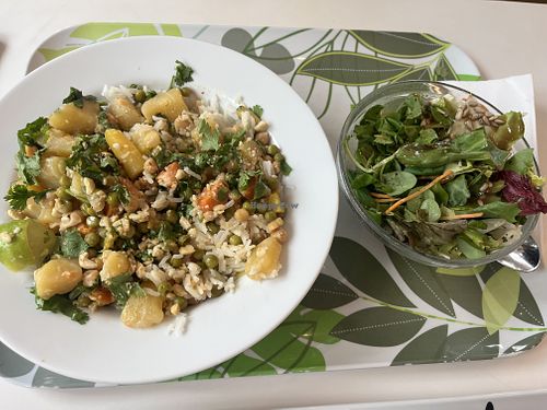 Chickpea curry with potatoes, carrots, & peas. served with lime rice, cashews, coriander, and wild herb salad. Vegan (Tuesday and Friday lunch)  at Flamingo Fresh Food Bar in Berlin