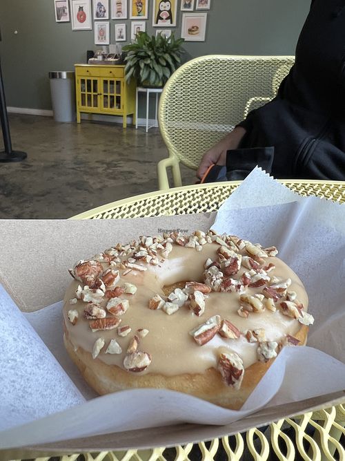 Maple Pecan donut, eating inside their store front   at Peaceful Provisions in Beacon