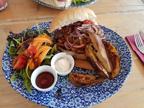 Seitan burger with vegan mayo. Usually comes with hash browns or sweet potato fries but they had sold out so they made us some potato wedges.  at Chapter 2 Coffee Shop  in Llandudno