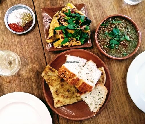 Deep fried aubergines with date molasses, Syrian lentils with chilli oil, bread basket with za'atar at Morito in East London