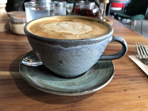 Latte in mug at Good Food Emporium Cafe - Illume in Narre Warren