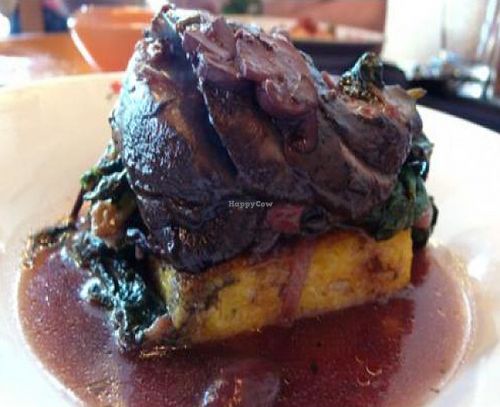Portobello Steak with Polenta and Greens: Marinated, roasted portobello mushrooms with rosemary polenta, braised greens, and red wine mushroom sauce. at Portobello Vegan Trattoria in Portland