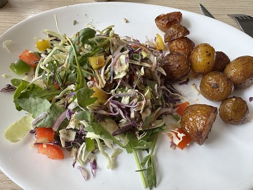 Side salad with vinaigrette and side of roasted potatoes    at Cafe Esmeralda in Nuuk