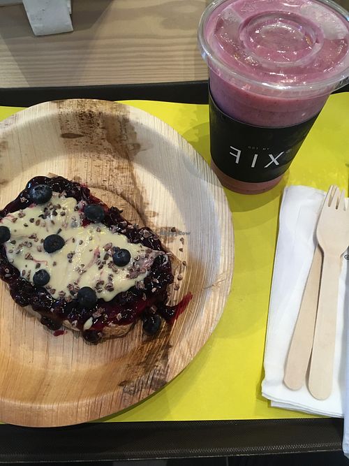 Toast with blueberry jam, nut butter, raw chocolate and dragonfruit and coconut smoothie  at DXB - FIX - T3 - B3 in Dubai