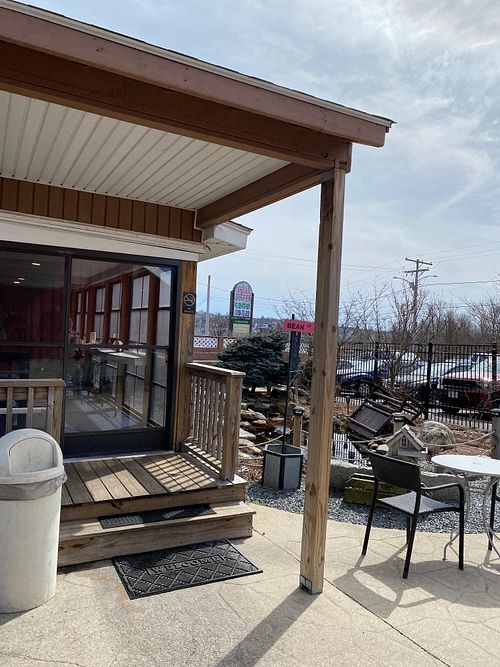 Outdoor seating area with a view of the screened in porch seating.  at The Pink Bean in Somerset