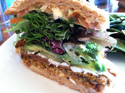 Golden Mean burger with tortilla chips, side view. at Golden Mean in Santa Monica