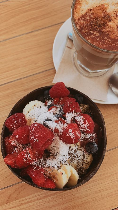 Açai Bowl with Oatmilk Cappuccino  at Celeiro Cafe in Peniche