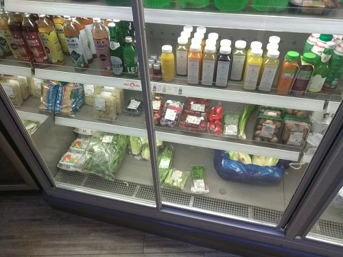 Fridge with juices and kombucha and sprouts & more at Delicious Food in Amsterdam