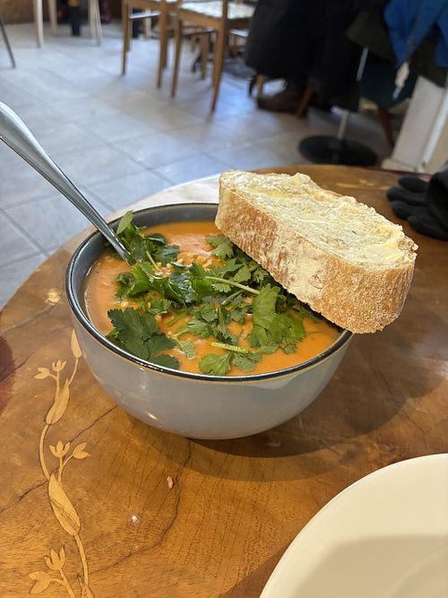 Peanut sweet potato soup and fresh coriander with bread  at Roihuvuoren Rio in Helsinki